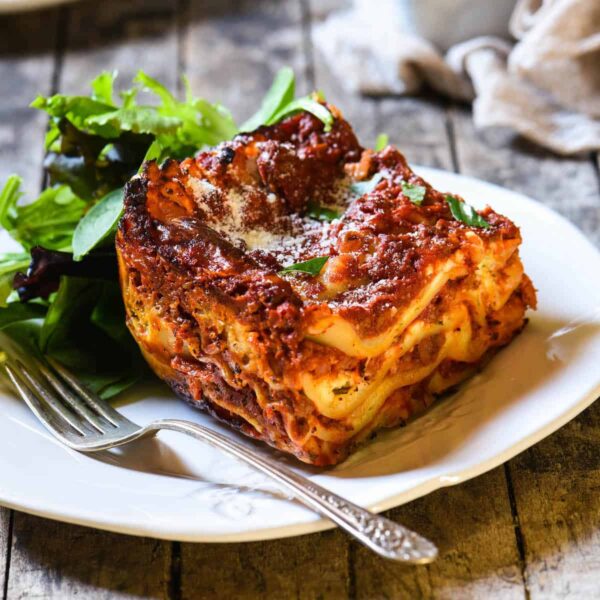 Calna Lasagna (Spacy minced beef sauce, bechamel sauce, mozzarella, parmesan cheese, with salad)